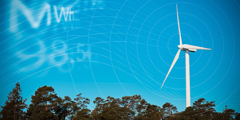 Ett vindkraftverk producerar förnybar el under en dag med blå himmel.