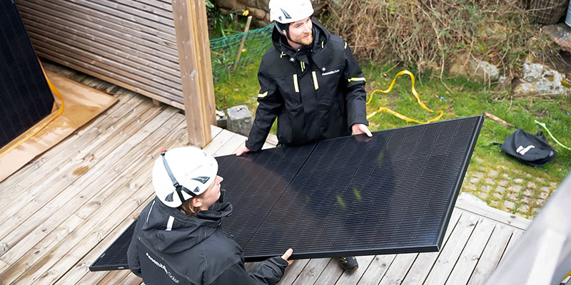 Två tekniker från Assemblin installerar solpaneler.